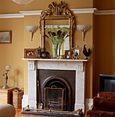 Living room with Victorian fireplace and ornate mirror