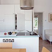 Kitchen dining area in studio apartment with view through to bedroom