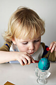 Little boy decorating an Easter Egg