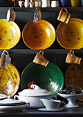 yellow ceramic bowls with cups on dresser in Evershot kitchen, Dorset, Kent, UK