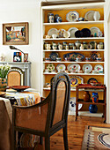 Collection of ceramics on dining room shelves in London home, England, UK