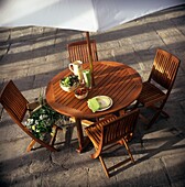 Wooden picnic table under sunshade