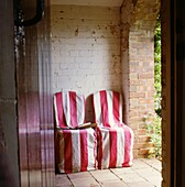 hairs with matching striped slip-covers and shears on white-washed garden porch