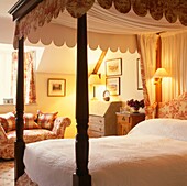 Four poster bed in yellow bedroom with co-coordinated fabric upholstery