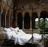 Unmade bed in castle interior