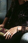 Lady in elegant brown lace dress with gift