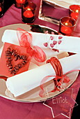Homemade napkin rings and tealights on table for Christmas in UK home