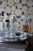 Drinks glasses on silver tray with bottles and decanter