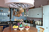 Storage rack above circular table in kitchen of Tiverton country home,  Devon,  England,  UK
