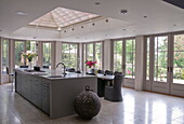 Light grey open plan kitchen and dining room in contemporary Haywards Heath home,  West Sussex,  England,  UK