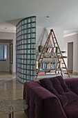 Brick glass partition with triangular shelving unit in contemporary Haywards Heath home,  West Sussex,  England,  UK