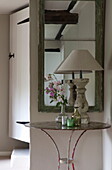 Lamp and cut flowers on side table in hallway of Kingston home,  East Sussex,  England,  UK