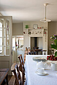 Teapot with strawberries on kitchen table in Kent home  England  UK