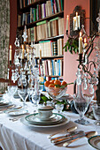 White crockery and silverware with glass candelabras in London home  England  UK