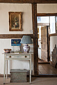Table with lamp at  timber-framed doorway in High Halden cottage  Kent  England  UK