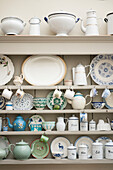 Assorted chinaware in kitchen dresser in Suffolk home  England  UK