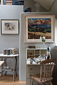 Desk and chair with framed artworks in Oxfordshire barn conversion  England  UK