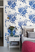 Blue and white floral wallpaper in bedroom of terraced house in Whitstable   Kent  England  UK