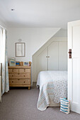 Wooden chest of drawers with built-in wardrobes in West Wittering home West Sussex England