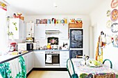 Colourful kitchen with chalkboard in London family home,  England,  UK