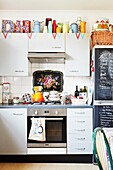 Collection of vases on top of fitted kitchen units in London family home,  England,  UK