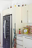 Chalkboard fridge in kitchen of London family home  England  UK