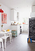 Chalkboard and table in sunlit Alloa kitchen  Scotland  UK