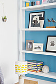 Ornaments on bookshelf with bright blue wall in Sheffield home  Yorkshire  UK