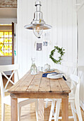 Chrome pendant light above wooden table in  West Yorkshire kitchen  UK