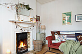 Christmas decorations on vintage mirror above fireplace in living room of London home  UK