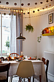 Lit candles on dining table with decorations in London home  UK