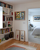 Bücherregal und gerahmte Kunst im Flur zum Schlafzimmer in einem Haus in Essex UK