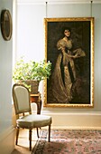 Still life of portrait painting with chair and flower arrangement