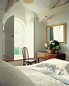 Country style white guest bedroom with white bed linen