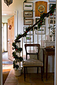 Hallway with festive garland wrapped around the stair banister