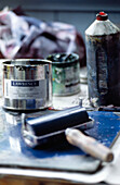 Paint roller and tin in artist's studio