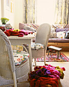 Basket of wool in country living room with white cane table and chairs