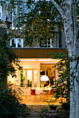 Lit kitchen extension with dining table and chairs