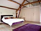 Geräumiges modernes Schlafzimmer im Dachgeschoss mit Doppelbett
