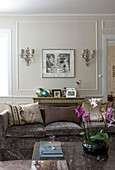 Eclectic living room with sofa and orchid on the table