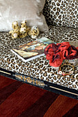 Leopard pattern sofa with small leopard toy close up