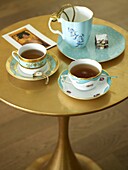 Gold painted side table with matching tea set