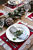 Ivy on napkin at place setting for Christmas dinner in Wiltshire farmhouse