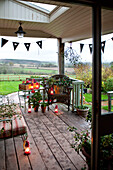 Lit lanterns and bunting on wooden porch exterior Hereford UK