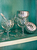 Glass and silverware on shelf