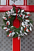 Weihnachtsgirlande an der roten Eingangstür eines Londoner Hauses UK
