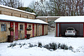 Car parked in garage of winter farm building conversion on Odense Denmark