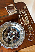 Wooden dice and chocolates with silverware on wood tabletop in Canterbury home England UK