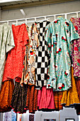 Assorted vintage dresses hang in London home UK