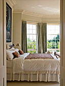 View through doorway to master bedroom of West London townhouse England UK